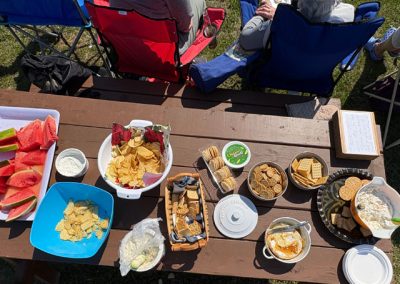 Picnic table full of snacks