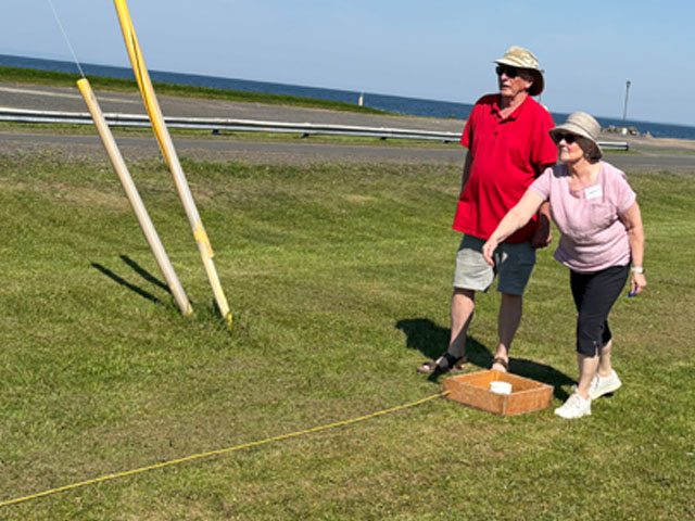 two people playing washer toss
